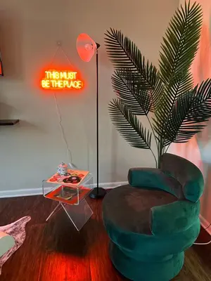a living room with a green chair and a lamp at Cozy King 2 bedroom at Easton near Airport in Columbus