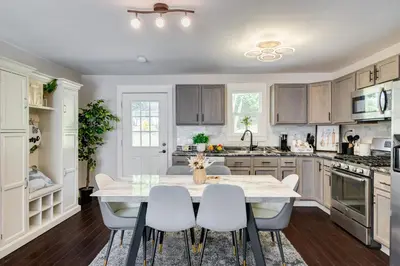 a kitchen with a white table and chairs at Luxury Midterm Rental for Families, Medical and Corporate Professionals Cincy in Cincinnati