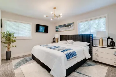 a bedroom with a bed and two windows at Luxury Midterm Rental for Families, Medical and Corporate Professionals Cincy in Cincinnati