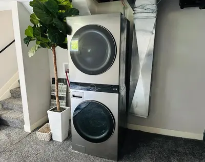 a washing machine and a dryer next to a wall at Luxury Midterm Rental for Families, Medical and Corporate Professionals Cincy in Cincinnati
