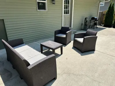 three chairs and a table on a patio at Luxury Midterm Rental for Families, Medical and Corporate Professionals Cincy in Cincinnati