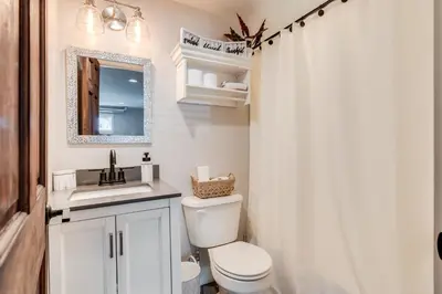 a bathroom with a toilet and a sink and a mirror at Luxury Midterm Rental for Families, Medical and Corporate Professionals Cincy in Cincinnati
