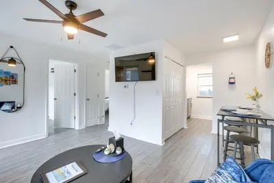 a living room with a ceiling fan and a table at Dayton Condo with Courtyard Less Than 3 to Downtown! in Dayton