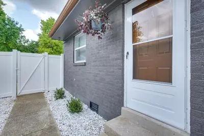 a house with a white door and a fence at Dayton Condo with Courtyard Less Than 3 to Downtown! in Dayton