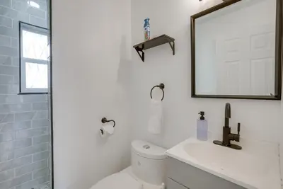 a bathroom with a white toilet and a mirror at Dayton Condo with Courtyard Less Than 3 to Downtown! in Dayton