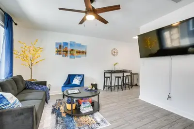 a living room with a couch and a flat screen tv at Central Dayton Apt Less Than Half-Mi to UD! in Dayton