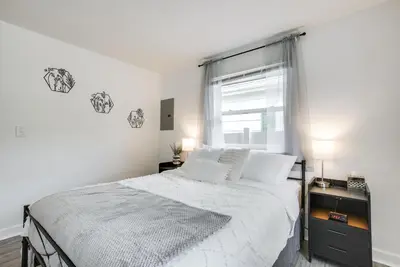 a white bedroom with a bed and a window at Central Dayton Apt Less Than Half-Mi to UD! in Dayton