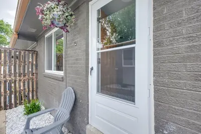 a door to a house with a chair and a wreath at Central Dayton Apt Less Than Half-Mi to UD! in Dayton
