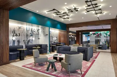a lobby with couches and a table and chairs at Hotel Celare, Cincinnati Midtown, a Tribute Portfolio Hotel in Cincinnati