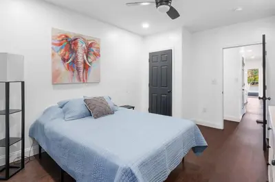 a bedroom with a bed and a painting on the wall at RiverSuite1 - A mesmerizing river and bridge view. in Russell