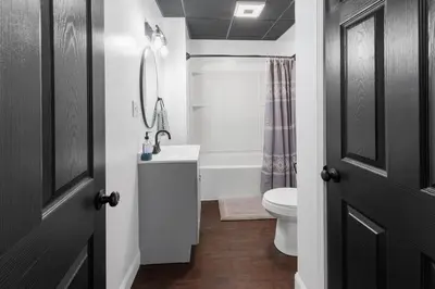 a bathroom with a white toilet and a sink at RiverSuite1 - A mesmerizing river and bridge view. in Russell