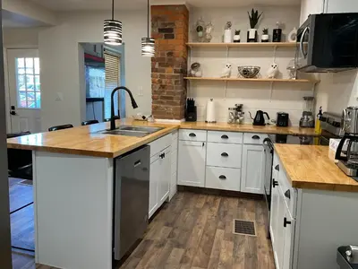 a kitchen with white cabinets and a sink at Modern Farmhouse in Covington