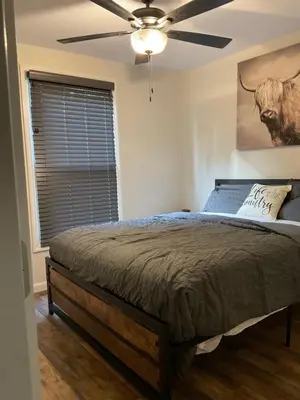 a bedroom with a bed with a ceiling fan at Modern Farmhouse in Covington
