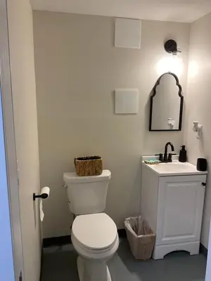 a bathroom with a white toilet and a sink at Modern Farmhouse in Covington