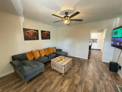 a living room with a couch and a ceiling fan at Modern Farmhouse in Covington