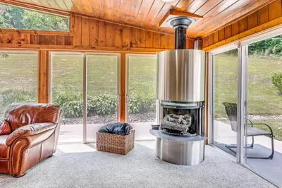 a living room with a fireplace in a house at Spacious Ohio Family Home on 5-Acre Property! in New Philadelphia