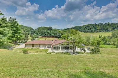 a house in the middle of a field at Spacious Ohio Family Home on 5-Acre Property! in New Philadelphia