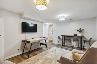 a living room with a ping pong table at Comfort & Style - Mins to CLE Clinic - Family Friendly in South Euclid