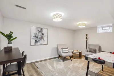 a living room with a table and chairs at Comfort & Style - Mins to CLE Clinic - Family Friendly in South Euclid