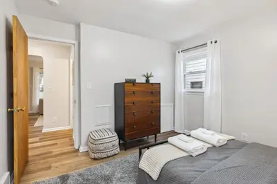 a bedroom with a bed and a dresser at Comfort & Style - Mins to CLE Clinic - Family Friendly in South Euclid