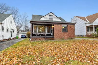 a house with a pile of leaves on the yard at Comfort & Style - Mins to CLE Clinic - Family Friendly in South Euclid