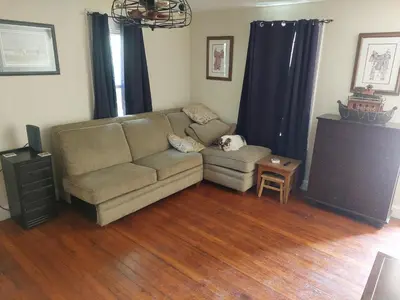 a living room with a couch and a table at 5BR Home - Pets Allowed by ARK Experience in Williamstown