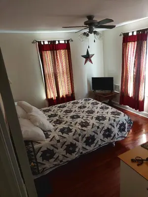 a bedroom with a bed with a black and white quilt at 5BR Home - Pets Allowed by ARK Experience in Williamstown