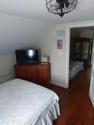 a bedroom with a bed and a flat screen tv at 5BR Home - Pets Allowed by ARK Experience in Williamstown