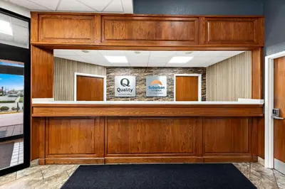 a lobby with a wooden door with a mirror at Suburban Studios Mason Near Kings Island in Mason