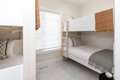 a small bedroom with bunk beds and a window at Inn At Fulton Boutique Hotel in Sandusky