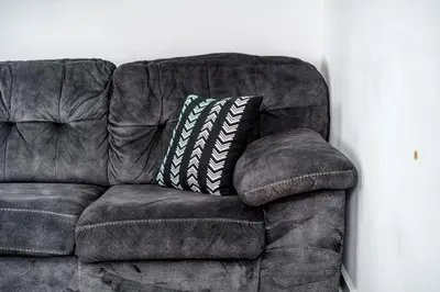 a brown leather couch with a pillow on it at Jungle House Luxury Homes - Columbus Downtown Short North - Steps to Convention Center & Nationwide Arena - Sleeps up to 6 - Free Parking - Over 5,800 Five Stars in Columbus