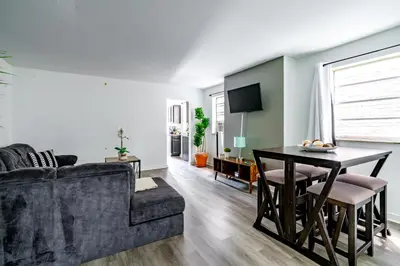 a living room with a couch and a table at Jungle House Luxury Homes - Columbus Downtown Short North - Steps to Convention Center & Nationwide Arena - Sleeps up to 6 - Free Parking - Over 5,800 Five Stars in Columbus