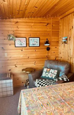 a room with a bed and a couch in a cabin at Little Loch home in Burton