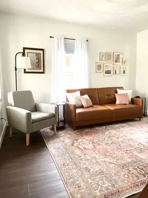 a living room with a couch and a chair at Cozy home in Akron in Akron