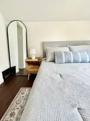 a bedroom with a large bed and a mirror at Cozy home in Akron in Akron