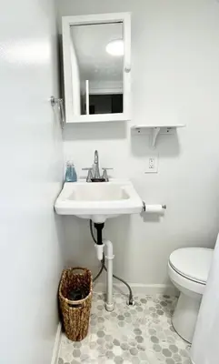 a bathroom with a sink and a toilet at Cozy home in Akron in Akron