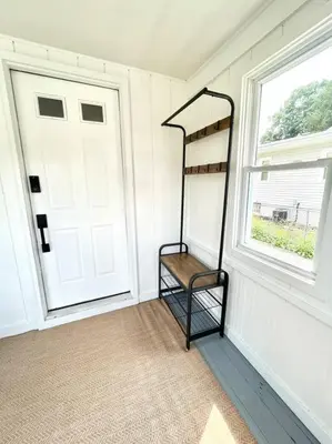 a room with a door and a shelf next to a window at Cozy home in Akron in Akron