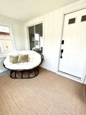 a room with a white couch in front of a door at Cozy home in Akron in Akron