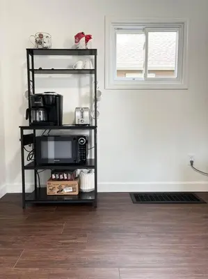 a microwave on a shelf in a room at Cozy home in Akron in Akron
