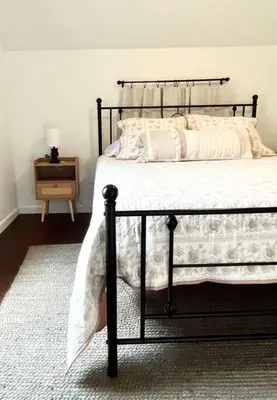 a bedroom with a bed with a black frame at Cozy home in Akron in Akron