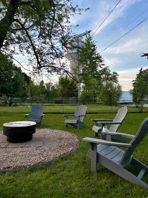 a group of chairs and a fire pit in a park at Captains Cove in Port Clinton