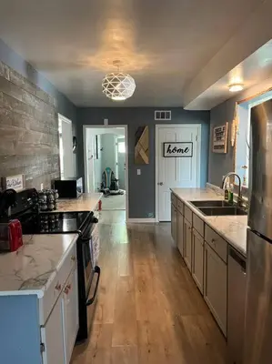 a large kitchen with a sink and a refrigerator at Captains Cove in Port Clinton