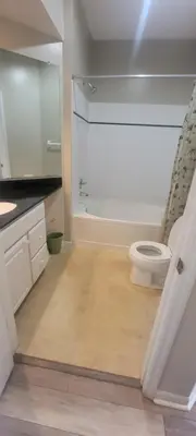 a white bathroom with a toilet and a shower at Nice Condo on Nature Preserve in Dublin