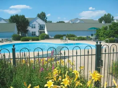 a fence with a pool in front of a house at Nice Condo on Nature Preserve in Dublin