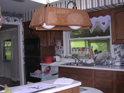 a kitchen with a sink and a microwave at Comfy Room in Huntington