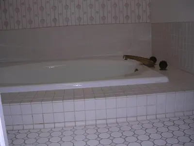 a bath tub with a faucet in a bathroom at Comfy Room in Huntington