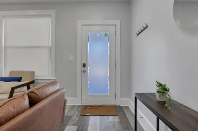 a living room with a couch and a glass door at The Columbus Adventure in Columbus