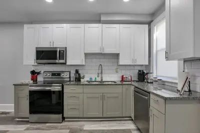 a kitchen with white cabinets and stainless steel appliances at The Columbus Adventure in Columbus