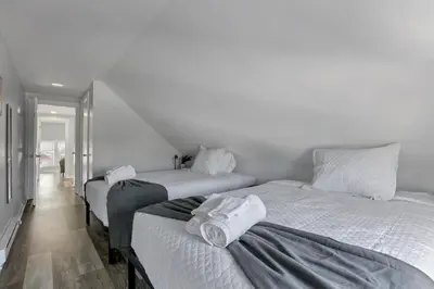 two beds in a room with white walls at The Columbus Adventure in Columbus