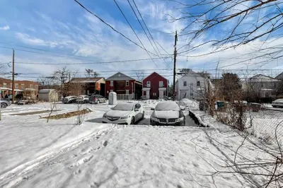 two cars parked in a parking lot covered in snow at The Columbus Adventure in Columbus